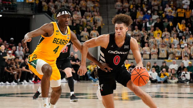 Jan 13, 2024; Waco, Texas, USA; Cincinnati Bearcats guard Dan Skillings Jr. (0) works around Baylor Bears guard Ja'Kobe Walter (4) during the first half at Paul and Alejandra Foster Pavilion. Mandatory Credit: Raymond Carlin III-USA TODAY Sports